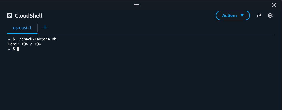 Screenshot of an AWS CloudShell terminal, region "us-east-1". The command ./check-restore.sh has been run and printed one line of output: "Done: 194 / 194".